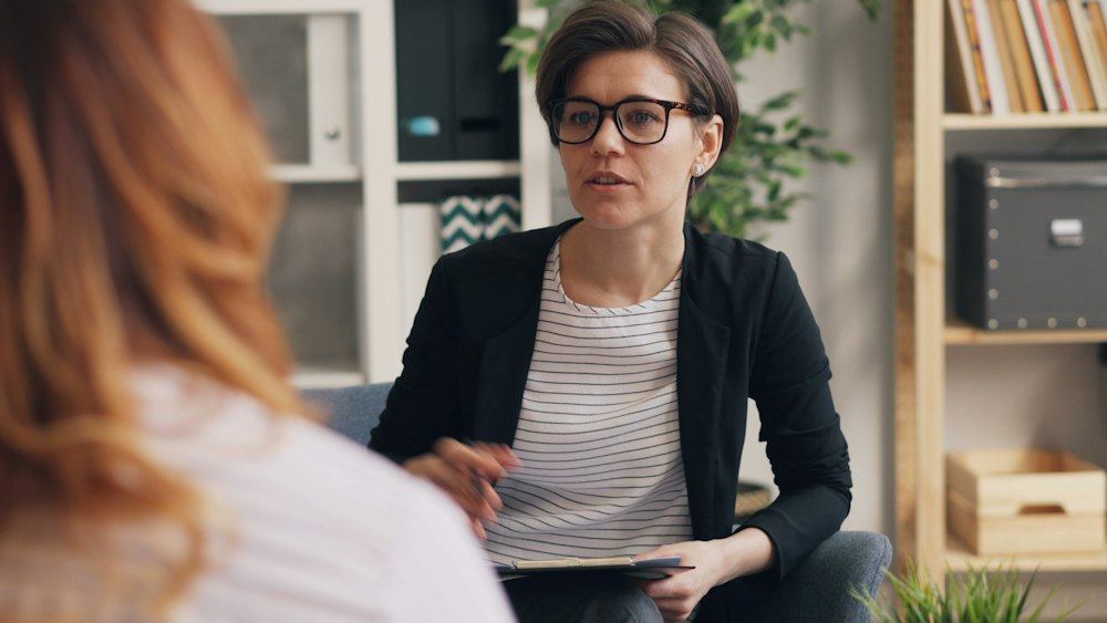 Therapist talking with a client