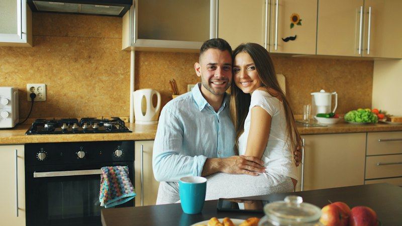 Couple smiling in a kitchen