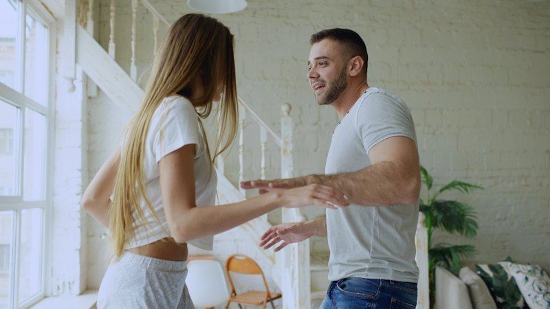 Couple dancing together in a bright room