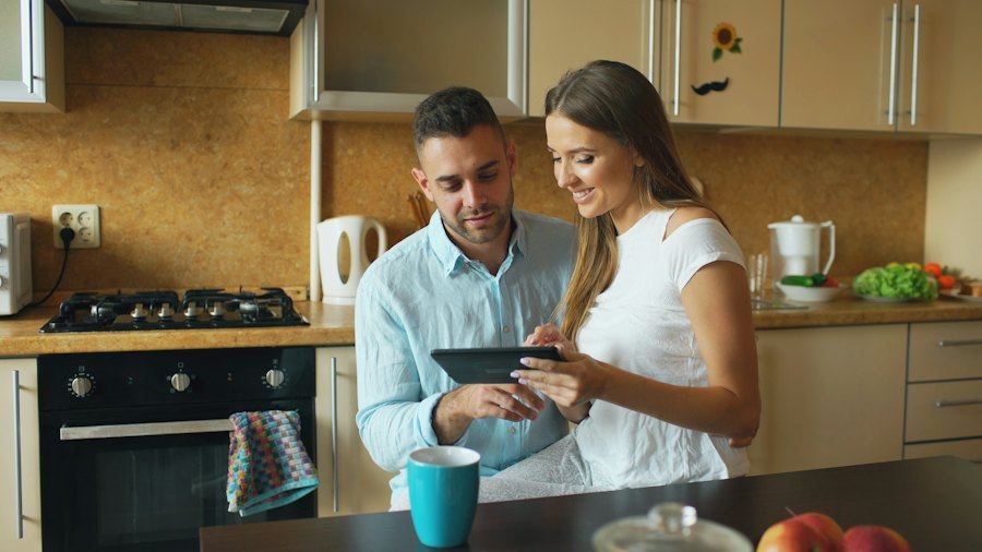Couple looking at a tablet in the kitchen